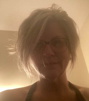 A head-and-shoulders picture of the author, messy hair, mostly backlit.